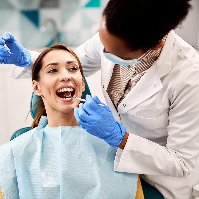 A woman receiving a dental checkup from her dentist