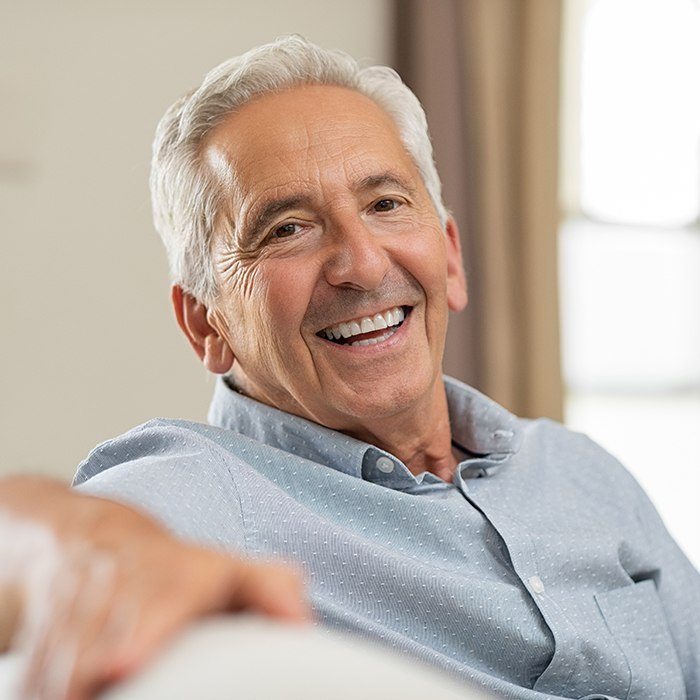 Older man sharing smile with natural looking denture