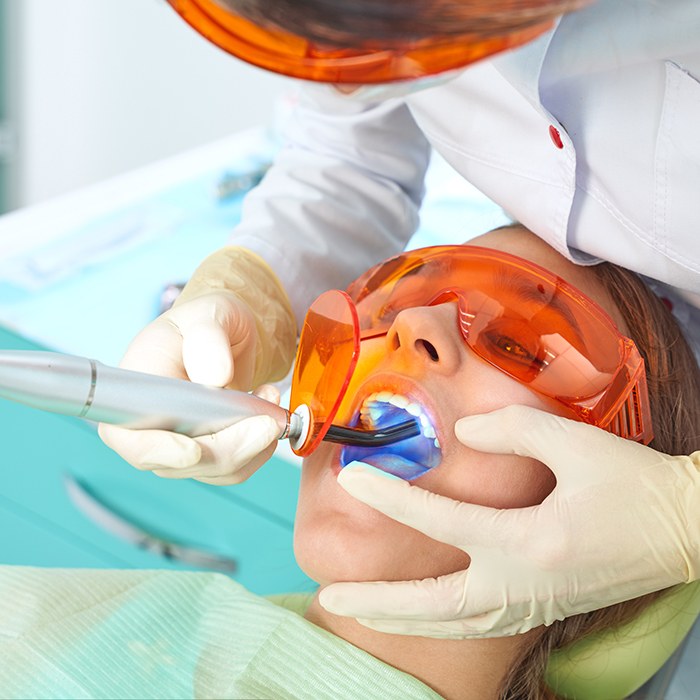 A woman receiving tooth-colored fillings from her dentist