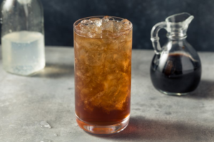 A sparkling water and balsamic vinegar mixture in a glass – if you squint it kinda looks like soda